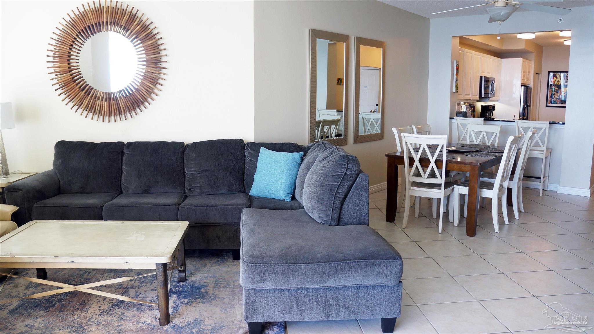 13597 Perdido Key Drive, Unit E12C Pensacola, FL 32507 - Photo 23 of 43 a living room with furniture and a large window