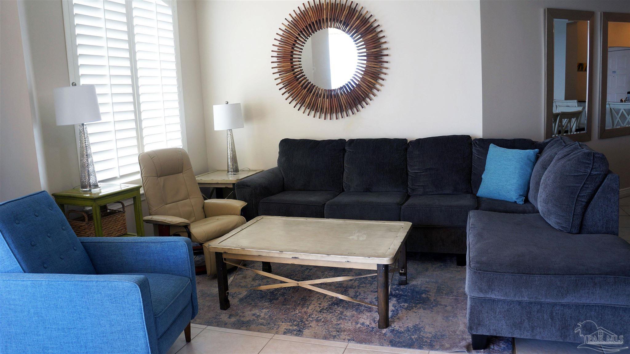 13597 Perdido Key Drive, Unit E12C Pensacola, FL 32507 - Photo 25 of 43 a living room with furniture and a large window