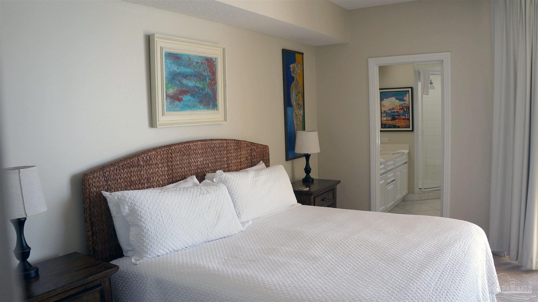 13597 Perdido Key Drive, Unit E12C Pensacola, FL 32507 - Photo 31 of 43 a bedroom with a bed and hallway