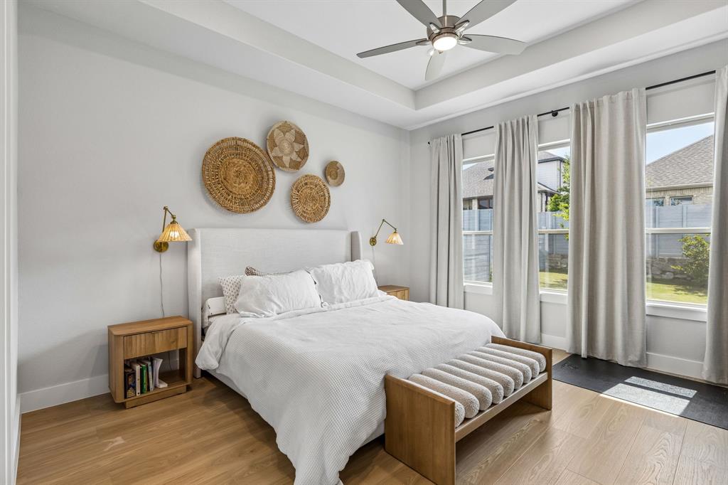 3004 Windy Rdg Road McKinney, TX 75071 - Photo 11 of 40 a bedroom with a bed and a chandelier