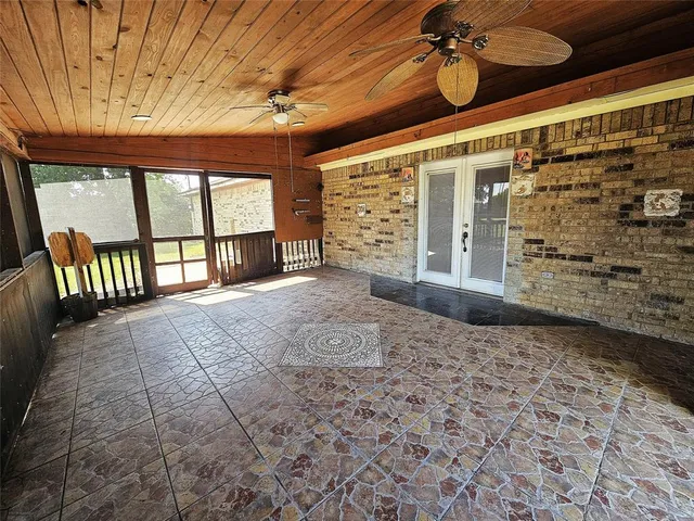 a view of a livingroom with a ceiling fan and window