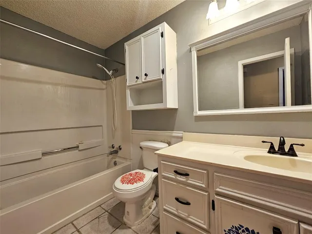 a bathroom with a tub sink and shower
