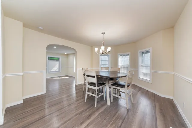 a dining room with wooden floor and breakfast area