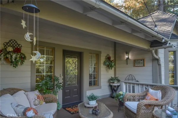 a view of a patio with couches table and chairs and potted plants