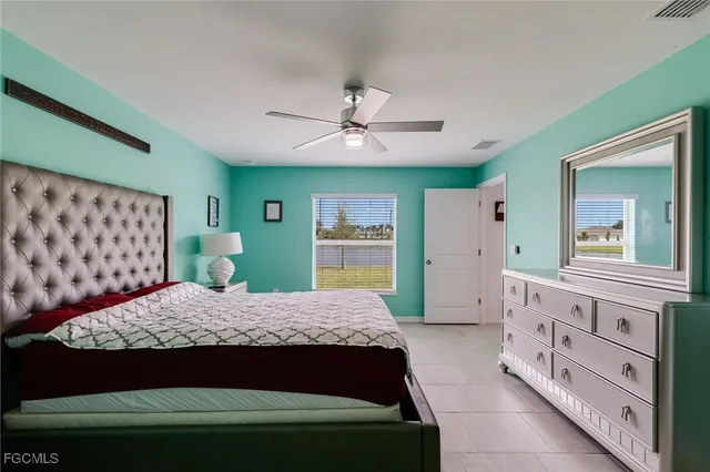 a bedroom with a large bed and a dresser