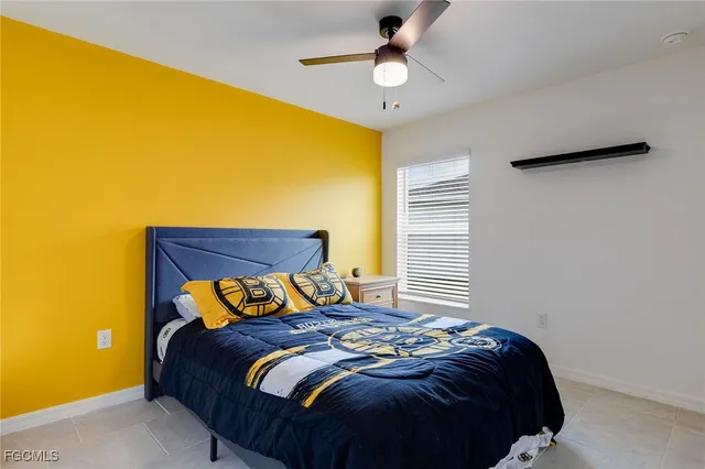 a bedroom with a bed and a ceiling fan