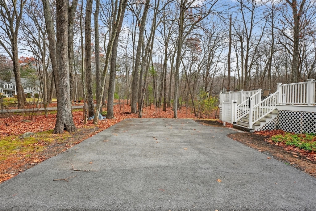 21 Fairbanks Road Chelmsford, MA 01824 - Photo 28 of 29 a backyard of a house with lots of green space and trees