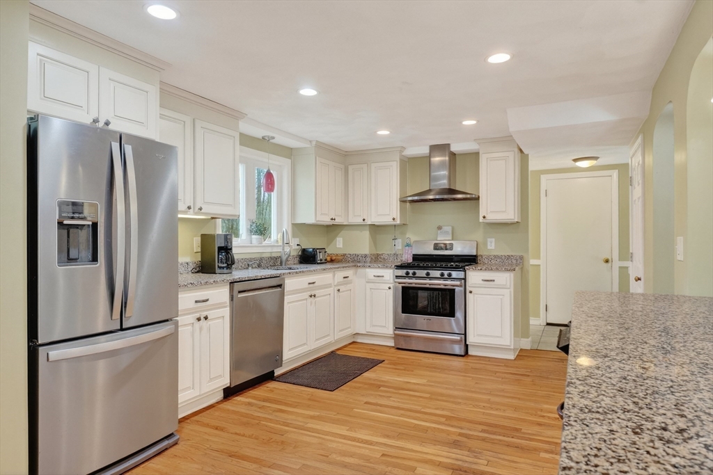 21 Fairbanks Road Chelmsford, MA 01824 - Photo 8 of 29 a kitchen with stainless steel appliances granite countertop a refrigerator stove oven and white cabinets