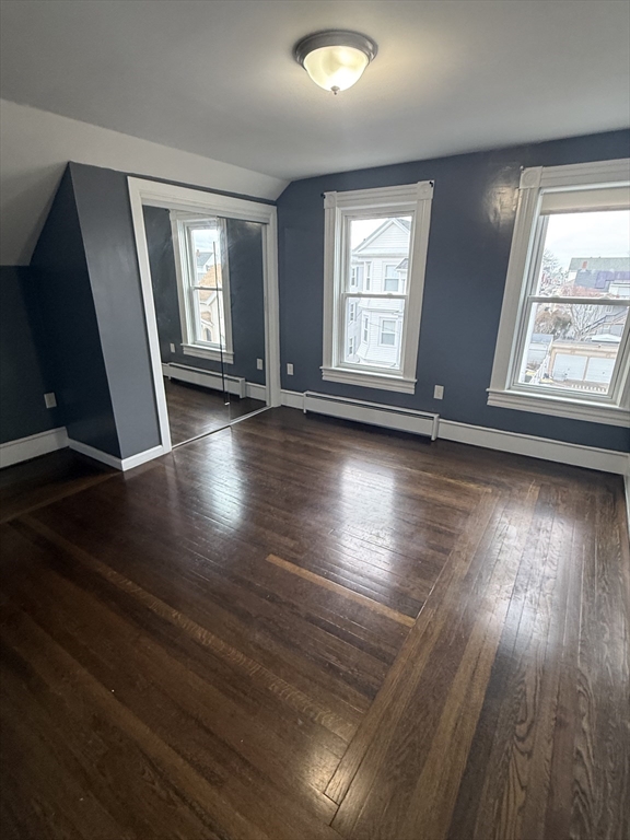 42 Mott Street, Unit 3 Fall River, MA 02721 - Photo 13 of 13 an empty room with wooden floor and windows
