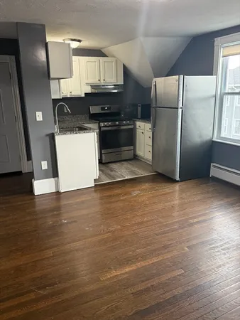 a kitchen with stainless steel appliances a refrigerator and a stove