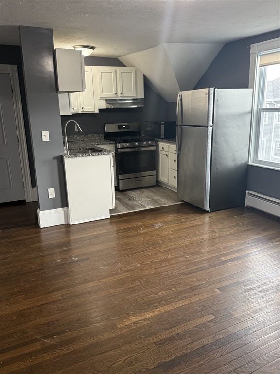 42 Mott Street, Unit 3 Fall River, MA 02721 - Photo 2 of 13 a kitchen with stainless steel appliances a refrigerator and a stove