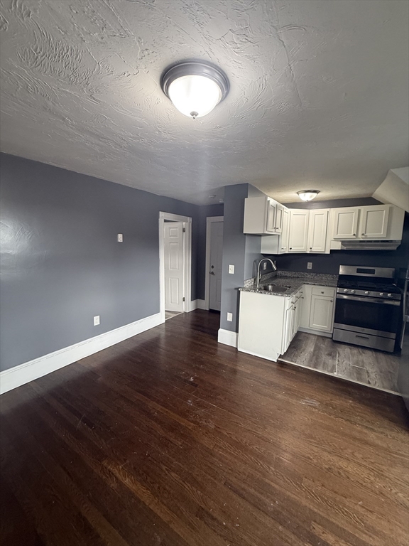 42 Mott Street, Unit 3 Fall River, MA 02721 - Photo 4 of 13 a view of a kitchen with a sink and a stove top oven