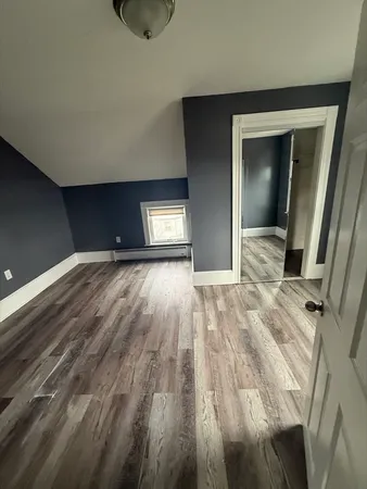 a view of an empty room and wooden floor
