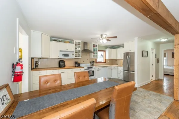 a kitchen with stainless steel appliances granite countertop a refrigerator and microwave