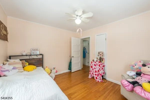 a bedroom with a bed and ceiling fan