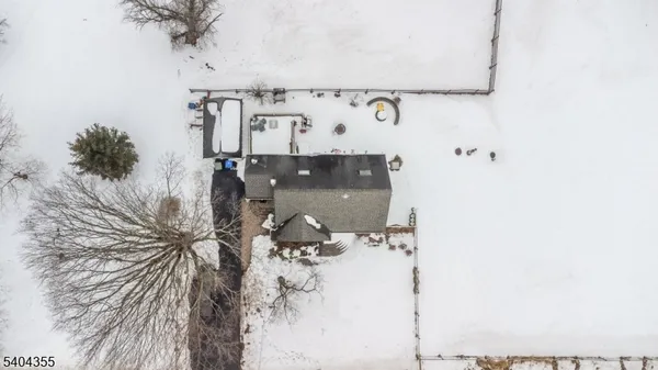 a view of a house with snow on the road