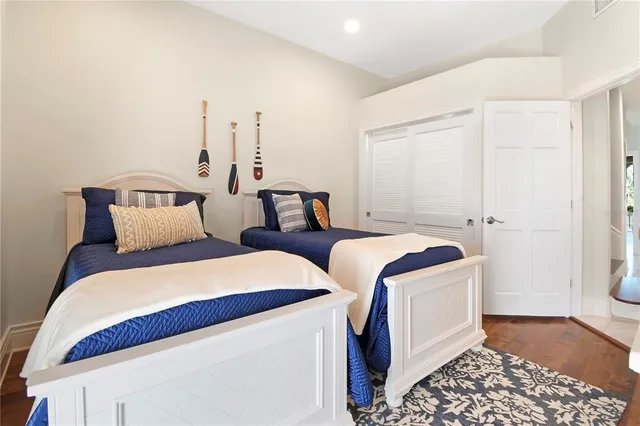 a view of a hallway with bathroom and mirror