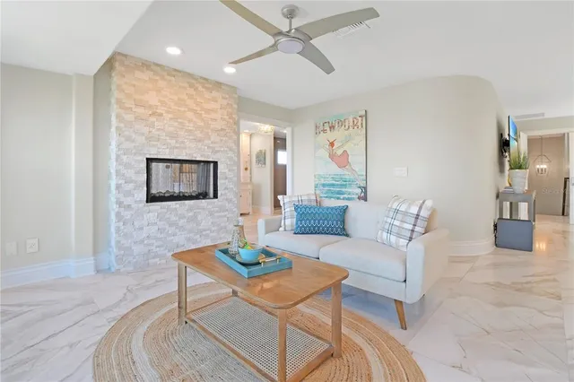 a view of a livingroom with a large window and wooden floor