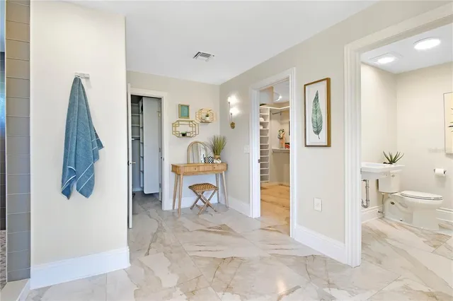 a living room with a couch and a chandelier