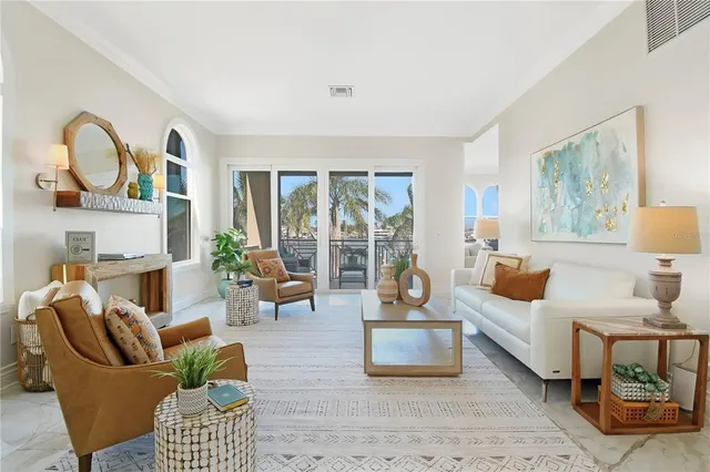 a living room with furniture and large windows