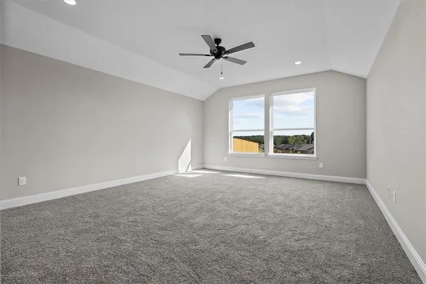 an empty room with a ceiling fan and window