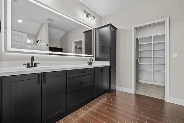 a bathroom with a shower and a sink