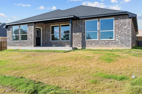 a view of a brick house with a swimming pool