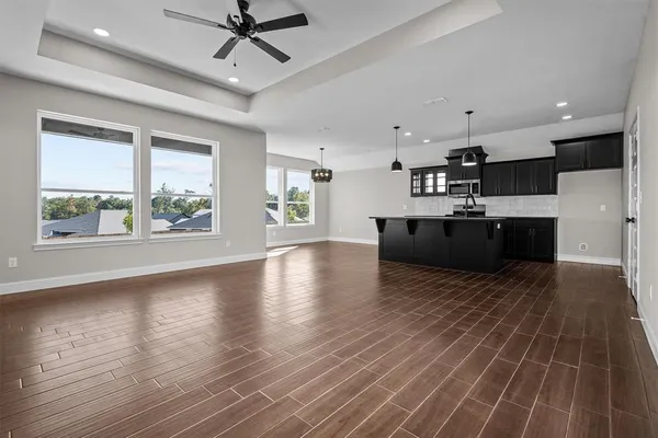 a view of kitchen and sink with wooden floor