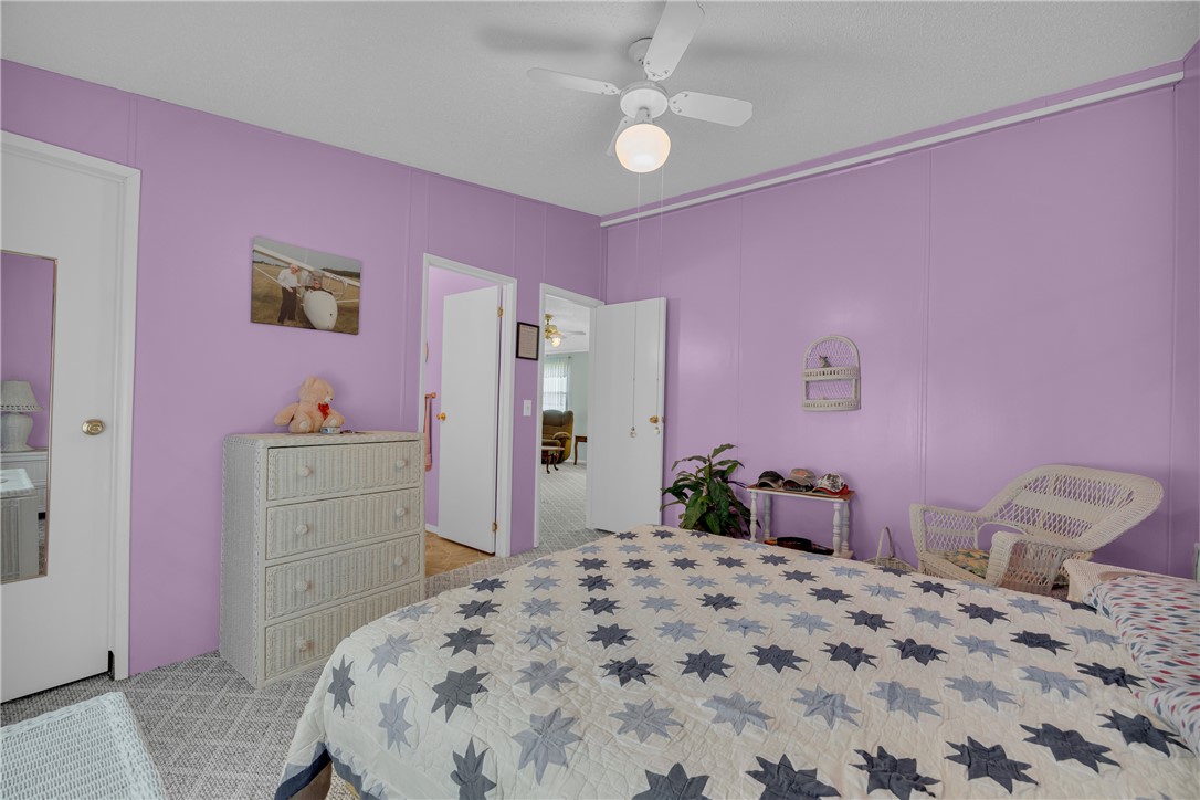 721 Cedar Crest Trail Walhalla, SC 29691 - Photo 25 of 47 A comforting bedroom space features a ceiling fan and textured flooring, offering a peaceful retreat.