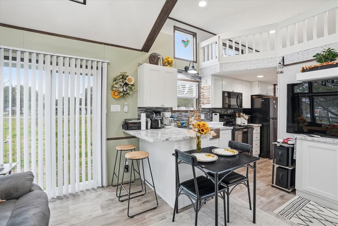 Undisclosed Address Rockport, TX 78382 - Photo 14 of 24 a kitchen with stainless steel appliances kitchen island granite countertop a table and chairs