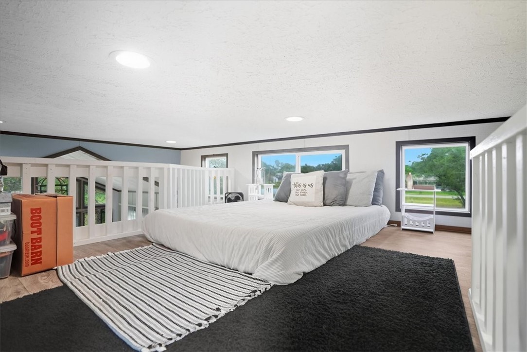 Undisclosed Address Rockport, TX 78382 - Photo 19 of 24 a spacious bedroom with a bed and a large window