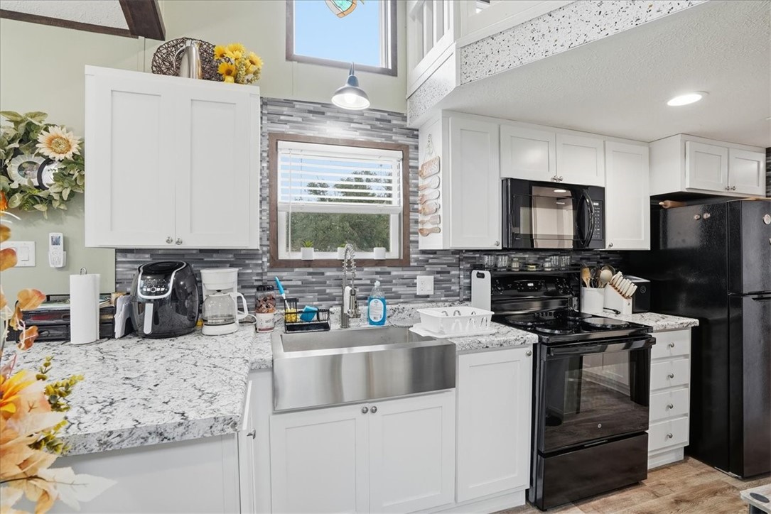 Undisclosed Address Rockport, TX 78382 - Photo 9 of 24 a kitchen with granite countertop a sink stove and cabinets