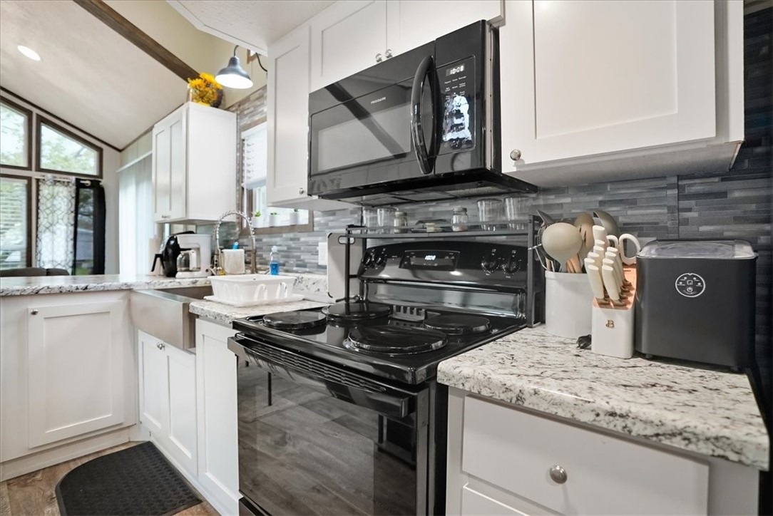 Undisclosed Address Rockport, TX 78382 - Photo 10 of 24 a kitchen with a stove and a microwave