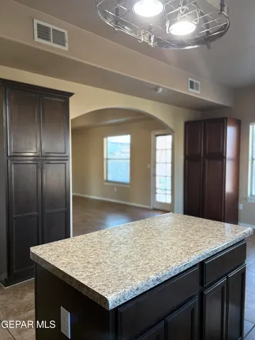 a kitchen with kitchen island sink refrigerator and refrigerator