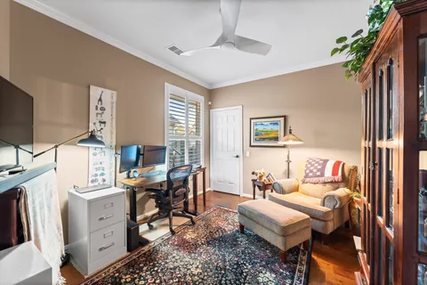 a living room with furniture a flat screen tv and a window