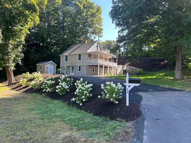 a house with a flower garden in front of it