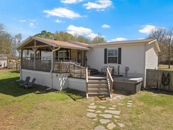 a view of a house with backyard and sitting area