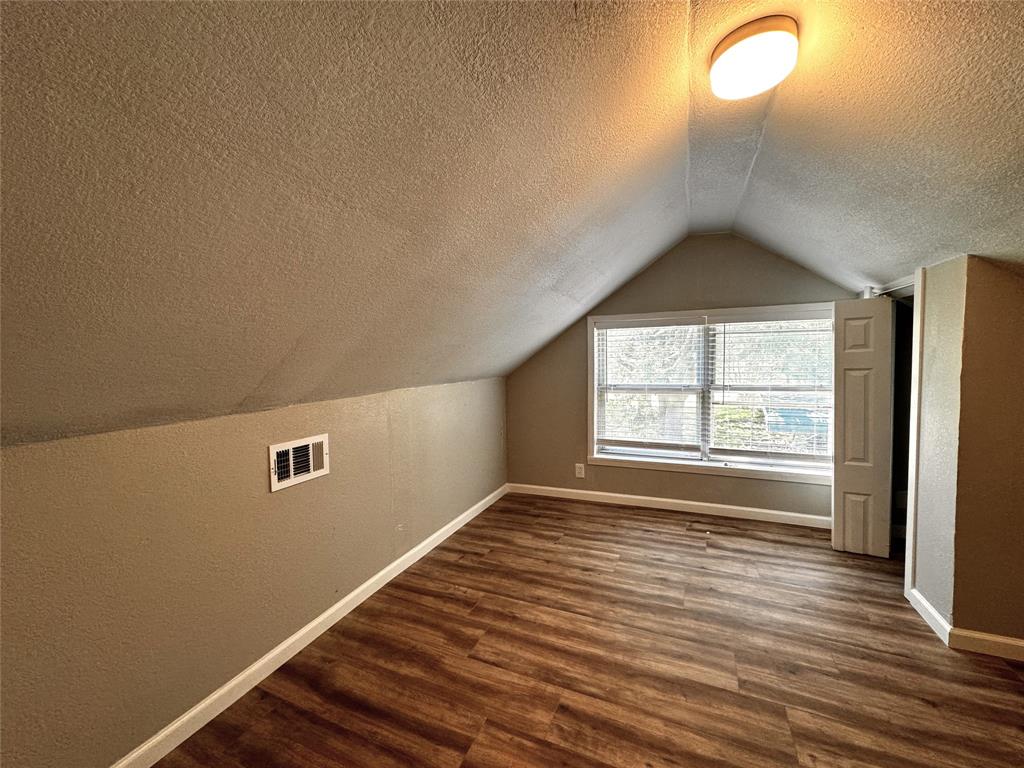 1931 Ave A Denison, TX 75021 - Photo 4 of 10 an empty room with wooden floor and windows