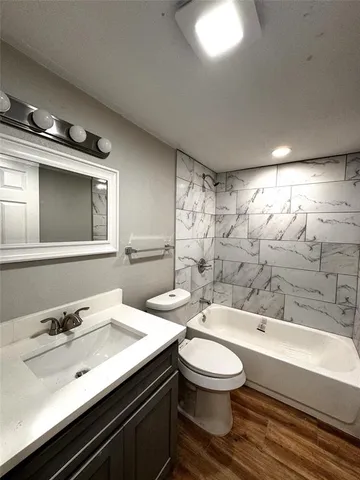 a bathroom with a sink a toilet and bathtub