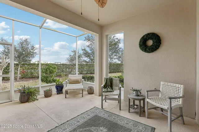 a living room with furniture a lamp and a large window
