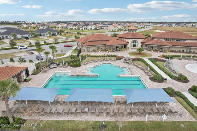 an aerial view of residential houses with outdoor space and swimming pool