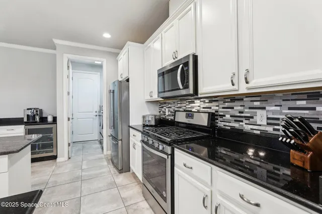 a kitchen with granite countertop a stove and a sink