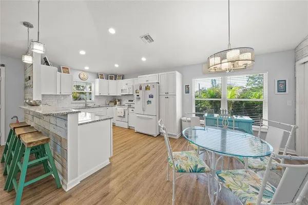a kitchen with white cabinets and white appliances