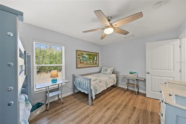 a bedroom with bed and a large window