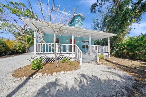 a view of a house with a tree in the background