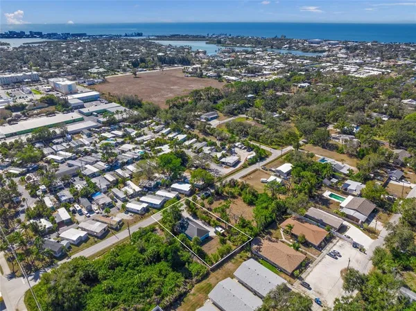 an aerial view of a residential houses with city view