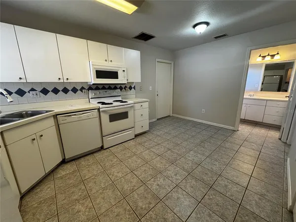 a kitchen with cabinets and appliances