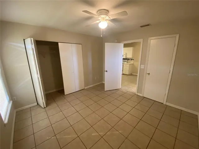 a view of an empty room and closet area