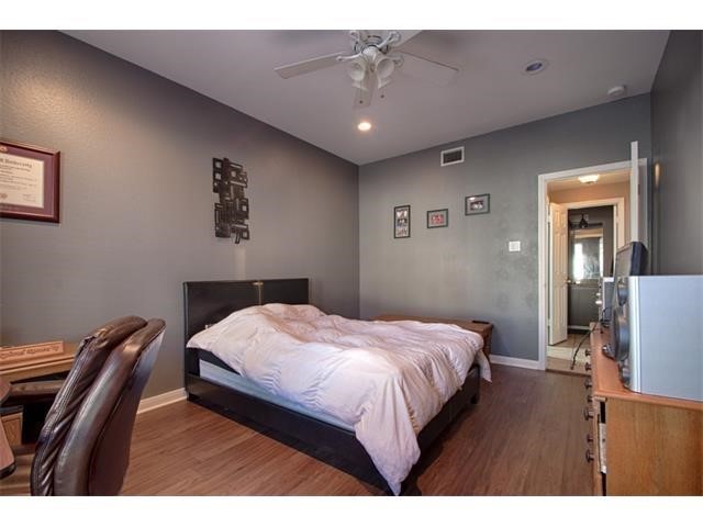 2529 Rio Grande Street, Unit 69 Austin, TX 78705 - Photo 15 of 25 a bedroom with a bed and a chandelier