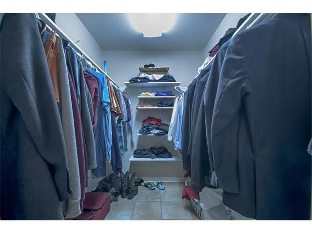 a view of a hallway with a dining table and chairs